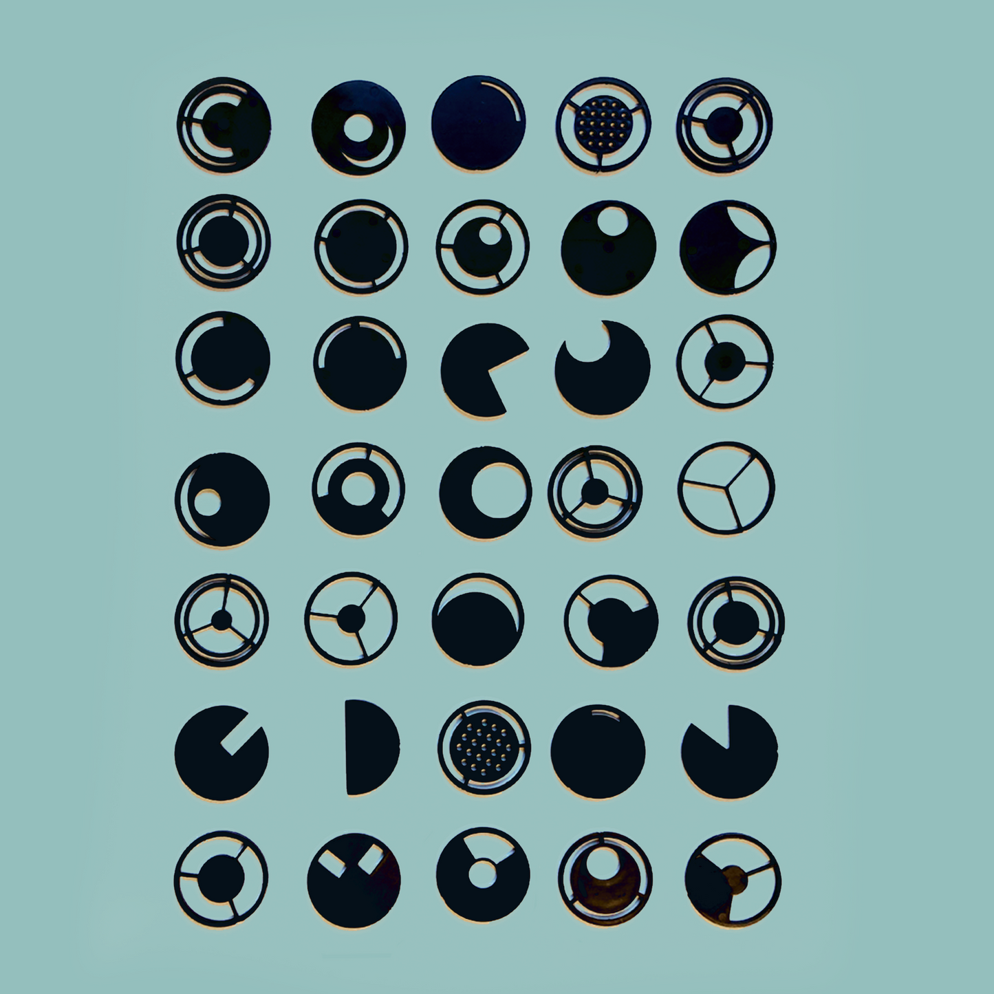 Photograph of various black filters laid out in a grid
